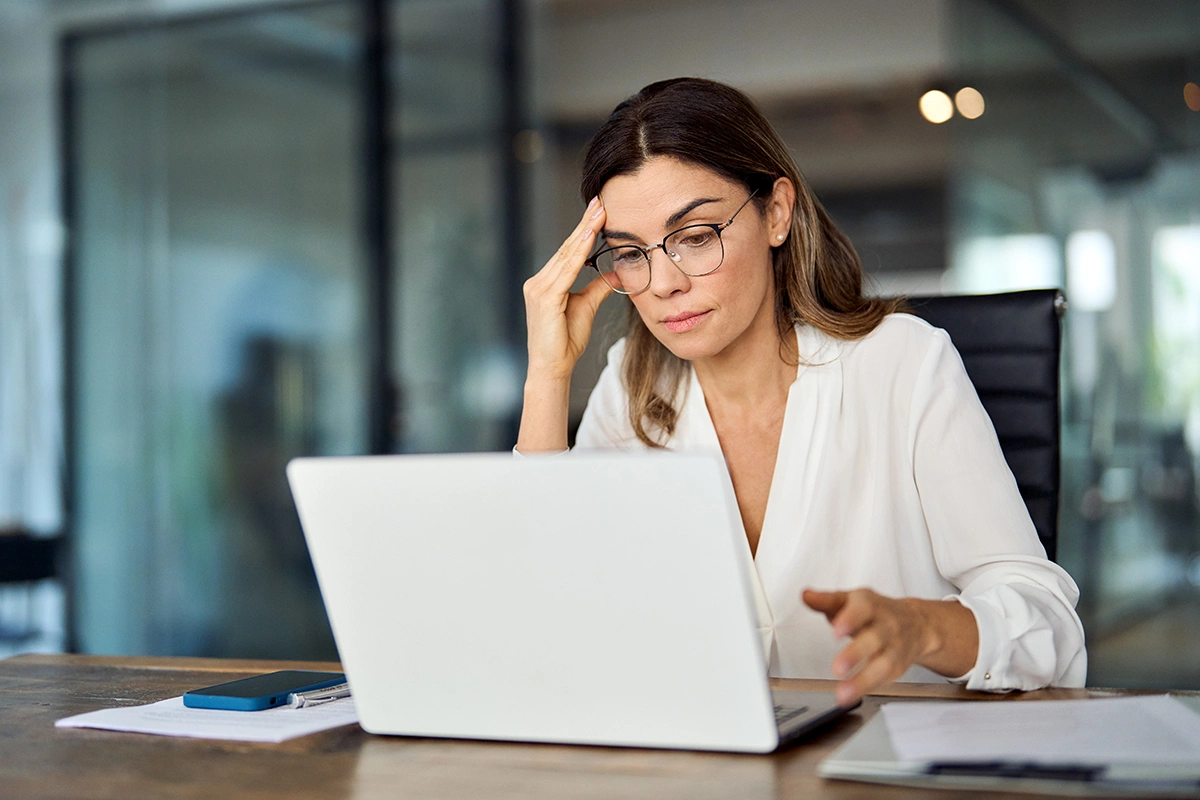 Income protection insurance for self-employed in Ireland - A business owner looking concerned while reviewing financial documents